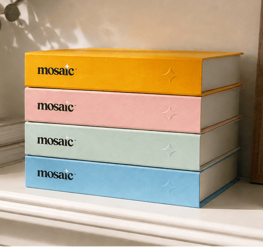 Stack of Mosaic Journal linen photo journals in orange, pink, green and blue
