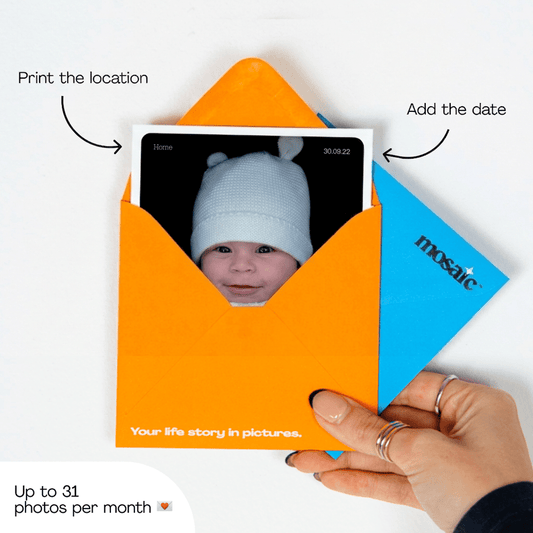 A 4×4 inch baby photo print arriving in a Mosaic Journal orange envelope